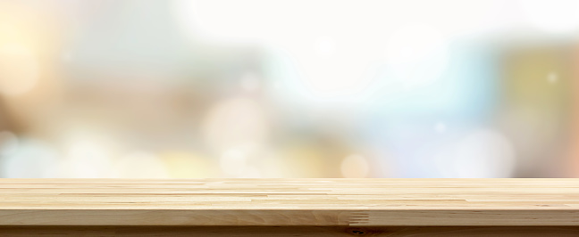 Side view of natural wood pattern table top against pastel blurred bokeh background suitable for montage or display your products (foods)