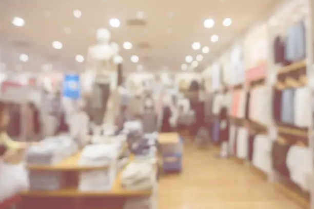 Photo of blurred abstract background of multicolored cotton clothing on the shelves of fashion and city shopping people crowd at marketplace shoe shop .vintage color