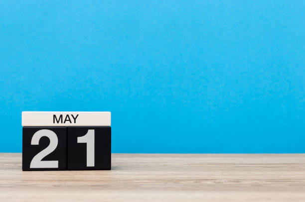 istock May 21st. Day 21 of month, calendar on blue background. Spring time, empty space for text 955882520