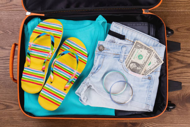 istock Suitcase with women summer clothes. 955886396