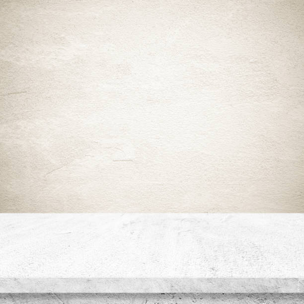 istock Empty white cement table over brown cement wall background, banner, table top, shelf, counter design for product display montage 955889736