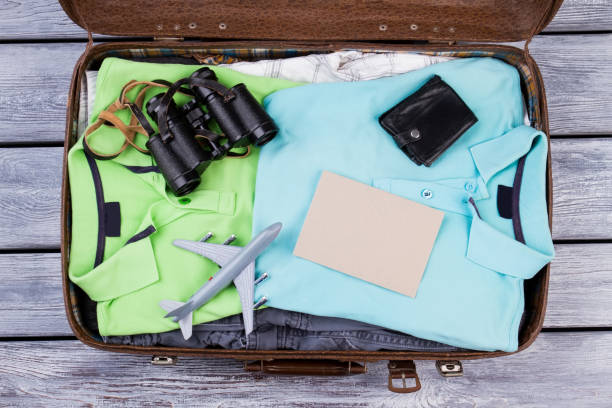 istock Luggage full of clothes, top view. 955890194