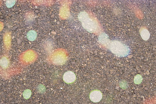 Natural textured grey sea pebble background. The view from the top