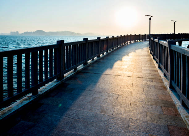 istock Sidewalk with railing by the sea 955903504