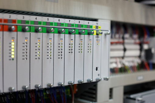 Industrial automation system with programmable controllers. Selective focus.