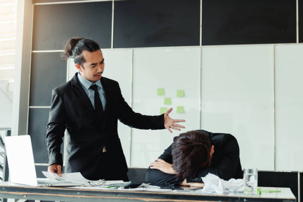 istock Manager reprimanding an employee in an office 955909686