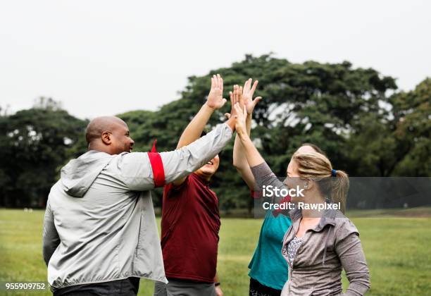 Diverse People Making A High Five Stock Photo - Download Image Now - Exercising, Group Of People, Outdoors
