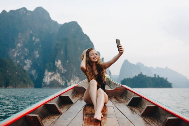 istock Beautiful woman posing on a boat 955912184