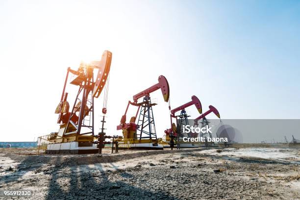 Oil Pumps Working Under The Sky Stock Photo - Download Image Now - Crude Oil, Drilling Rig, Gasoline