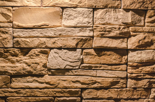 istock Decorative brick wall in the light of burning lamp. 955913122
