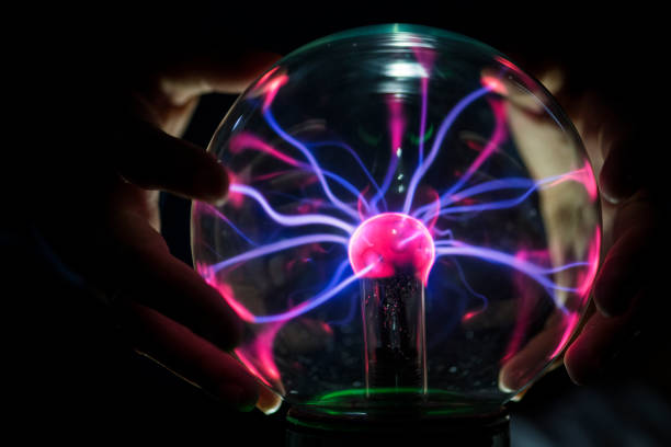 Closeup of a plasma globe in the darkness Closeup of a plasma globe in the darkness plasma ball photos stock pictures, royalty-free photos & images