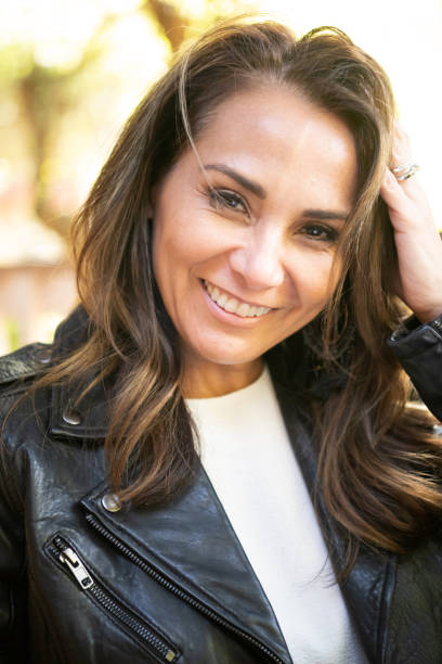 istock Smiling hispanic or middle eastern woman wearing a leather jacket 955916798