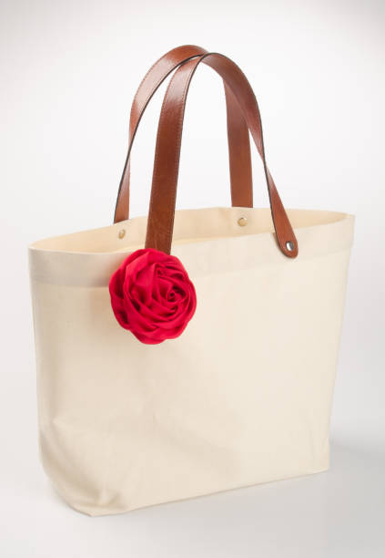 istock bag or shopping handbag with rose on background 955917290