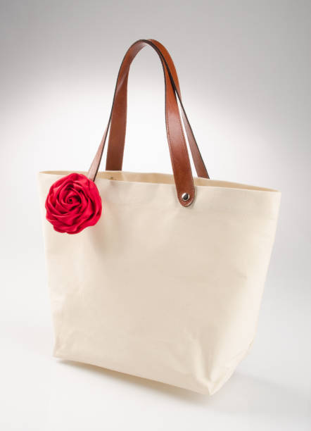 istock bag or shopping handbag with rose on background 955917316