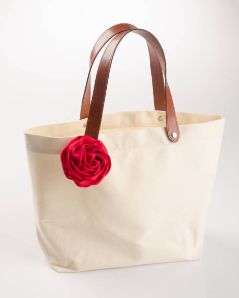 istock bag or shopping handbag with rose on background 955917334