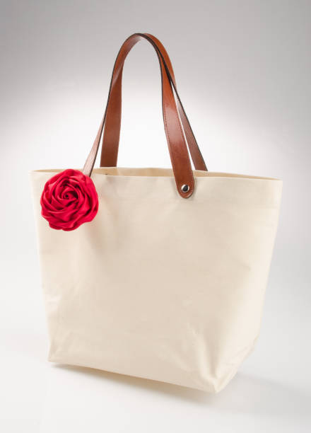 istock bag or shopping handbag with rose on background 955917346