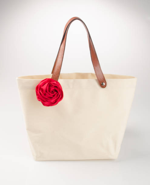 istock bag or shopping handbag with rose on background 955917420