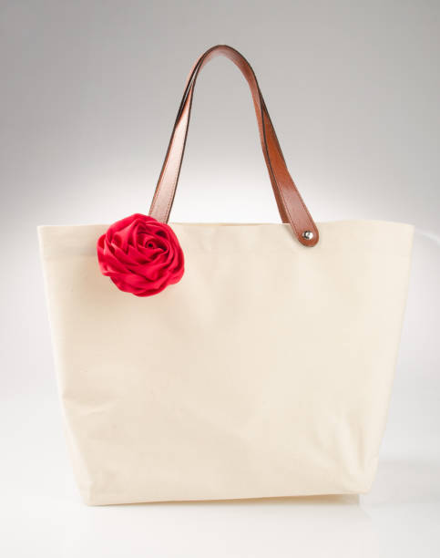 istock bag or shopping handbag with rose on background 955917456