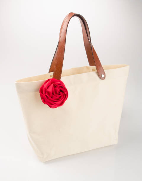 istock bag or shopping handbag with rose on background 955917482