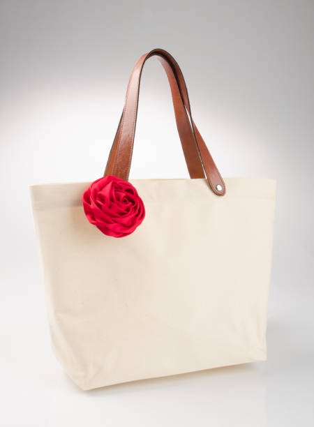 istock bag or shopping handbag with rose on background 955917522