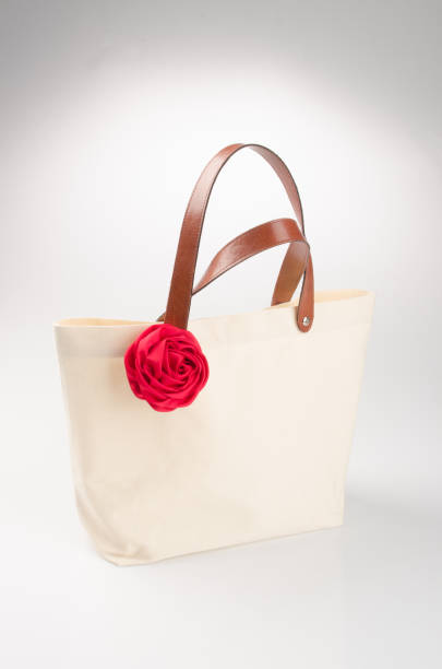 istock bag or shopping handbag with rose on background 955917526