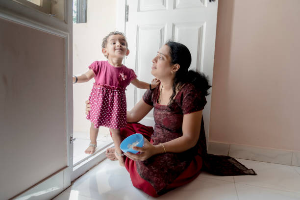 mother feeding daughter Indian, mother, food, lunch, feeding, Bangalore, cerial stock pictures, royalty-free photos & images