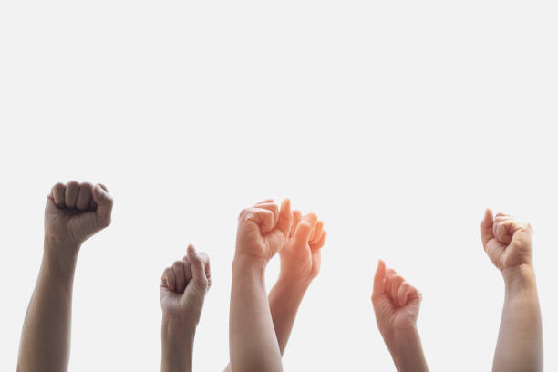 istock Group people of fists raised with sunlight 955921392