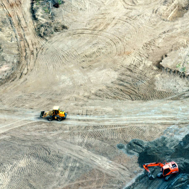 istock Aerial view of excavator working at construction site 955921494