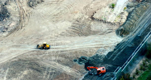 istock Aerial view of excavator working at construction site 955921746