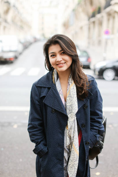 istock Asian smiling student standing in street background, walking after classes 955926722