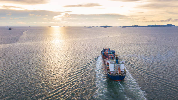 istock Cargo ship in the sea sunset time 955931890