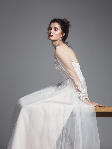 Studio portrait of beautiful woman wearing wedding gown