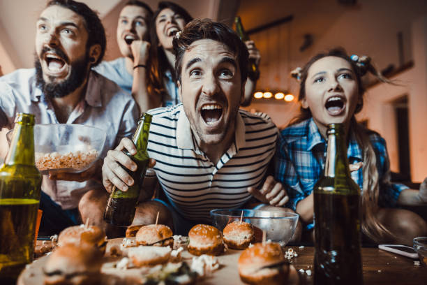 istock Cheering while watching a sports game on TV at home! 955933630