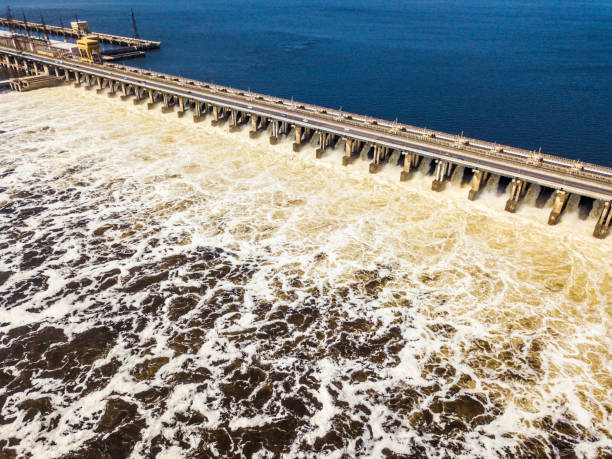 istock aerial view of hydro power plant damb with water passing through it 955936740