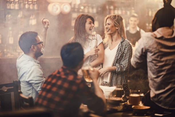istock Group of joyful friends having fun on a party in a pub. 955941164