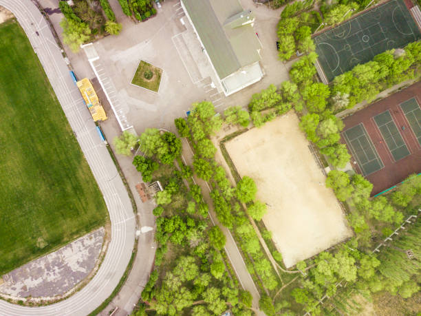 istock aerial sport courts stadium surrounded by green trees 955941280