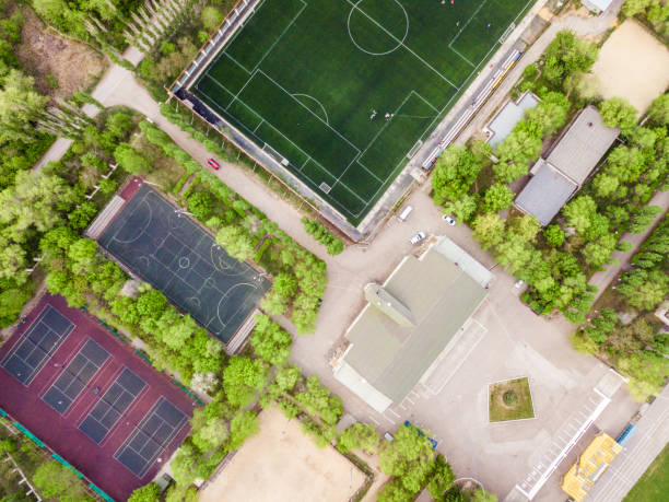istock aerial sport courts stadium surrounded by green trees 955941306