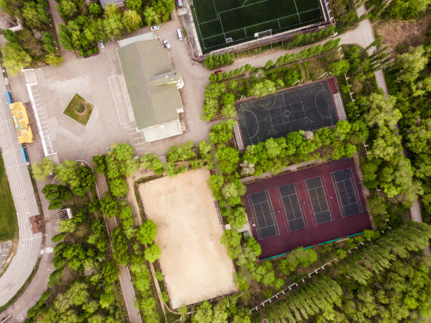istock aerial sport courts stadium surrounded by green trees 955941370