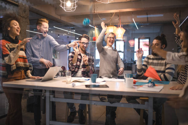 istock Large group of playful creative people having fun at casual office. 955945980