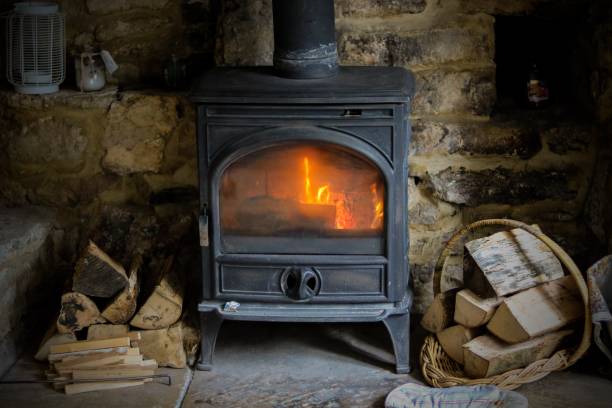 Wood burning stove Cotswolds cottage log burner wood burning stove stock pictures, royalty-free photos & images
