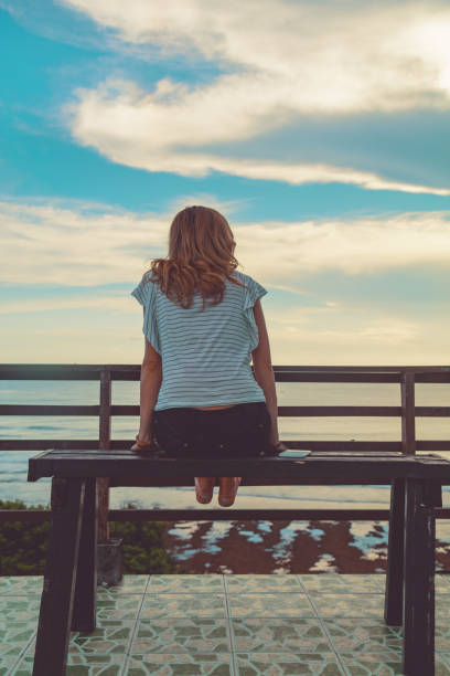istock Female looking at the distant ocean / sea view. 955951042