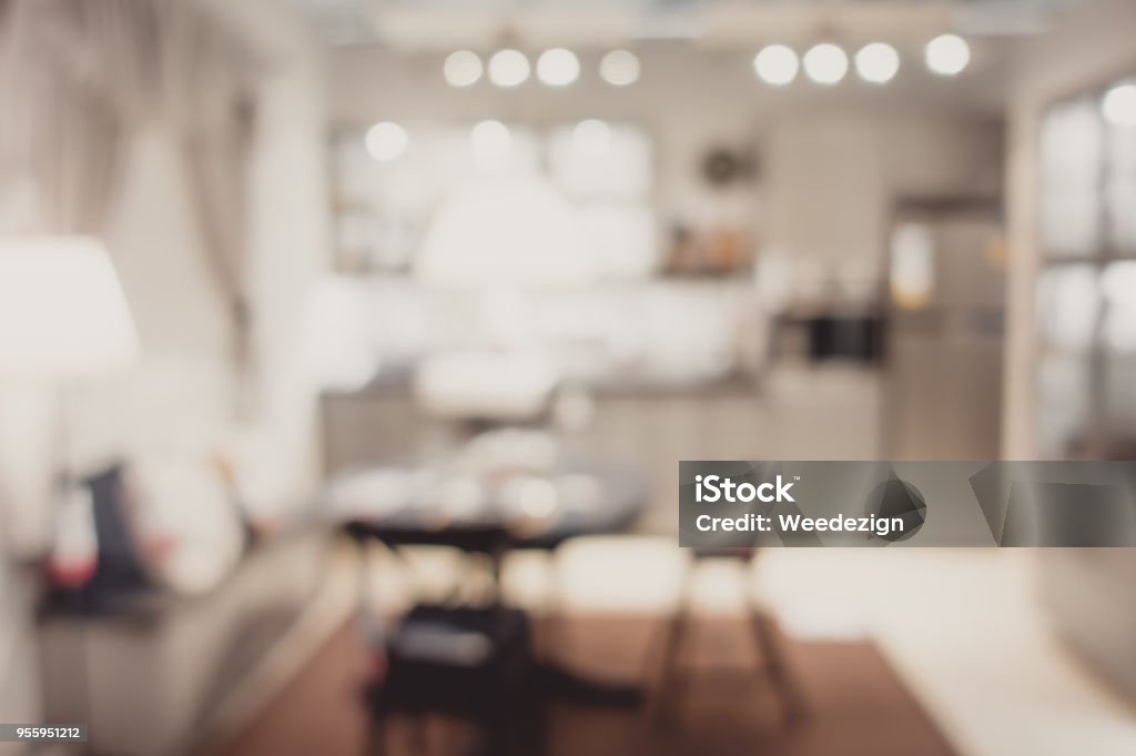 Blurred background modern kitchen and dinning room in house with bokeh light.lifestyle backdrop. Blurred background modern kitchen and dinning room in house with bokeh light.lifestyle backdrop Backgrounds Stock Photo