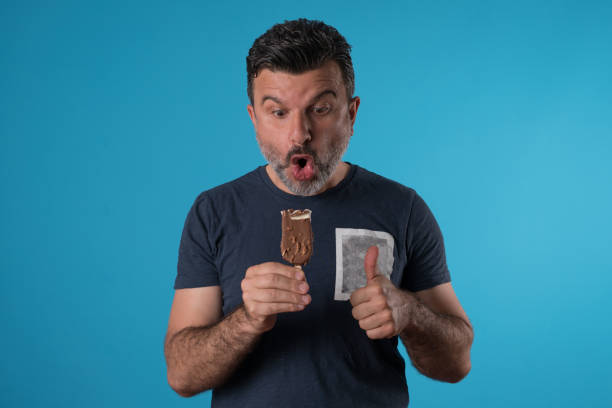 istock Positive man eating ice cream 955951510