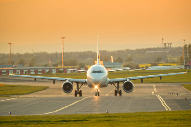 istock Big commercial passengers airplane jetliner approaching on runway 955952490