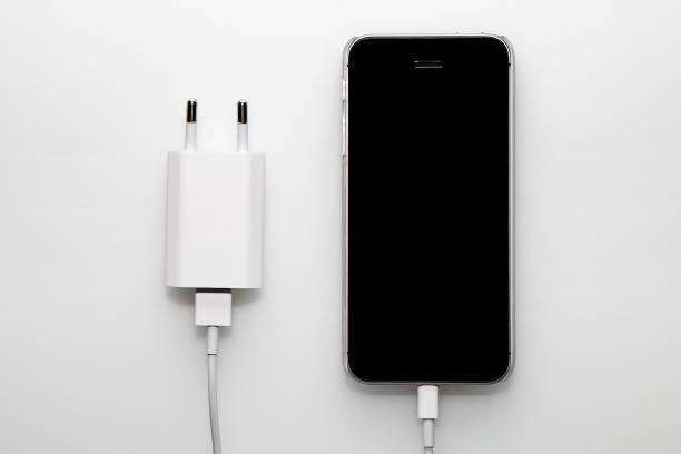 istock Black smartphone, adapter and cable on a white background 955952898