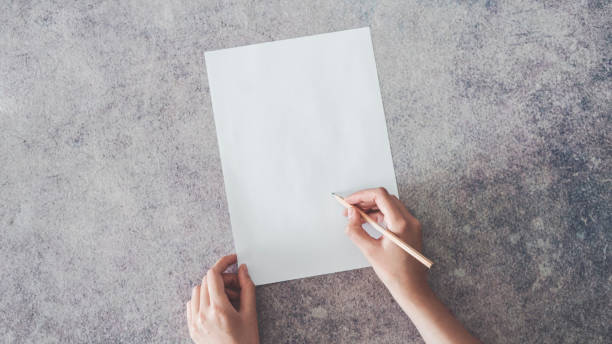 istock Hand writing on blank paper with pencil 955952918
