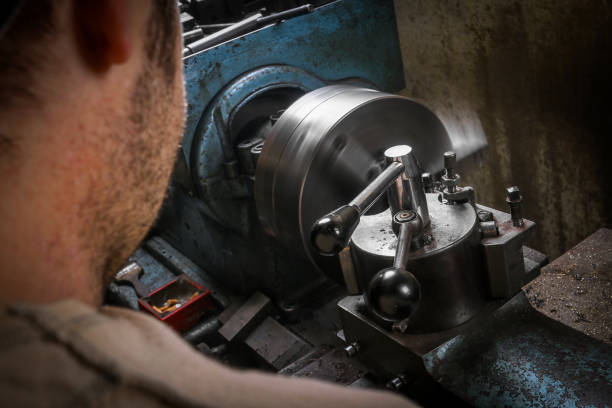 istock Metal worker shaping metal on lathe machine 955957766