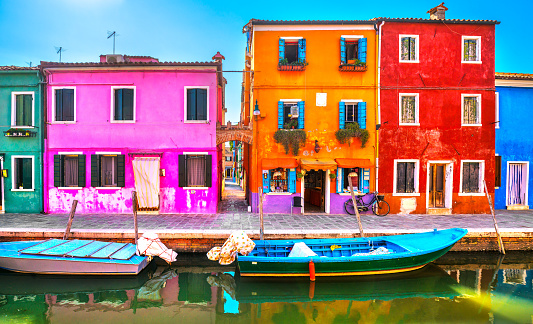 Venice landmark, Burano island canal, colorful houses and boats, Italy. Europe