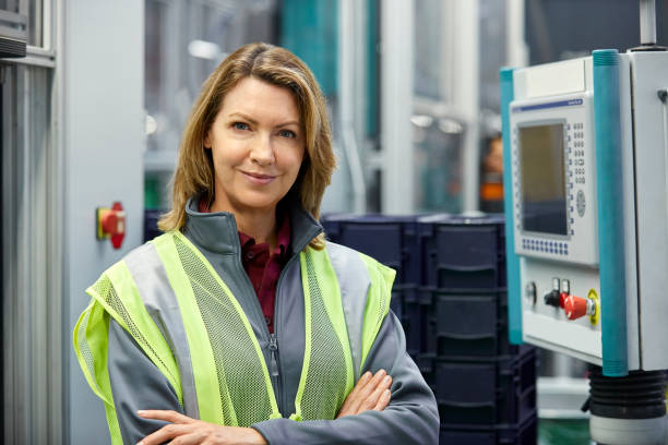 istock Female engineer with arms crossed in car plant 955959536