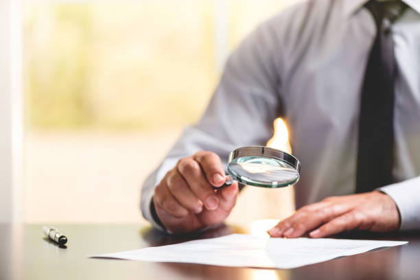 istock Businessman Reading Contract Details Before Signing 955962346